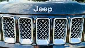Black Jeep badge on an SUV's grille.