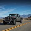 A Jeep Gladiator driving on a wide open road.