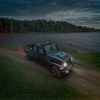 The 2025 Jeep Gladiator Dark Sky driving at dusk