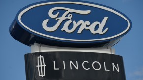 The Ford and Lincoln logos above a dealership doing SUV recall work
